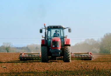 Tractor and farmer working in the field